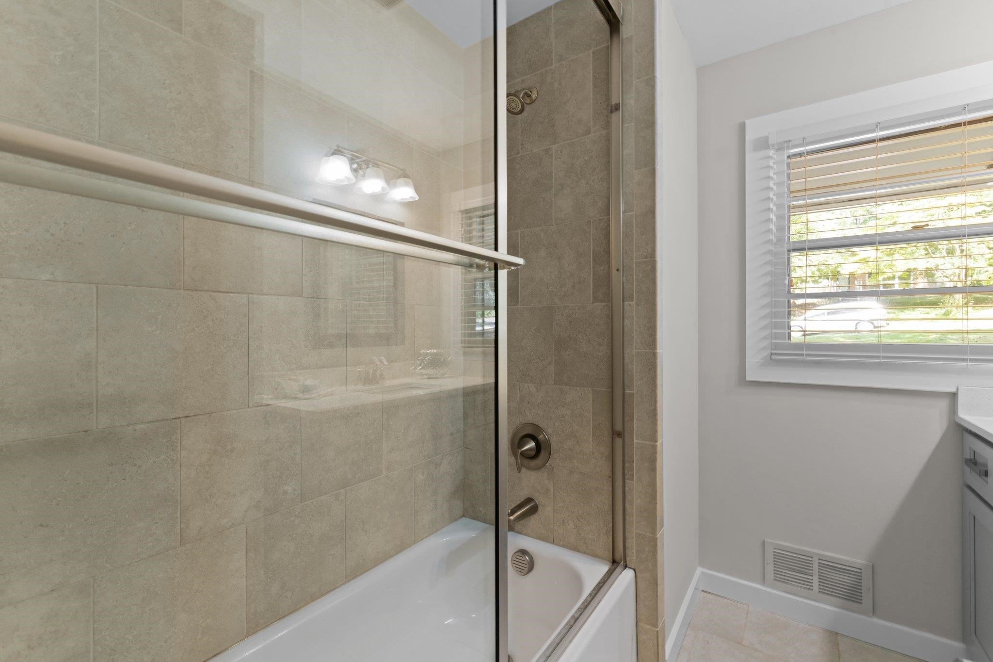 3605 Octavia Street Raleigh, NC 27606 - Photo 40 of 50 a bathroom with a bathtub and a shower