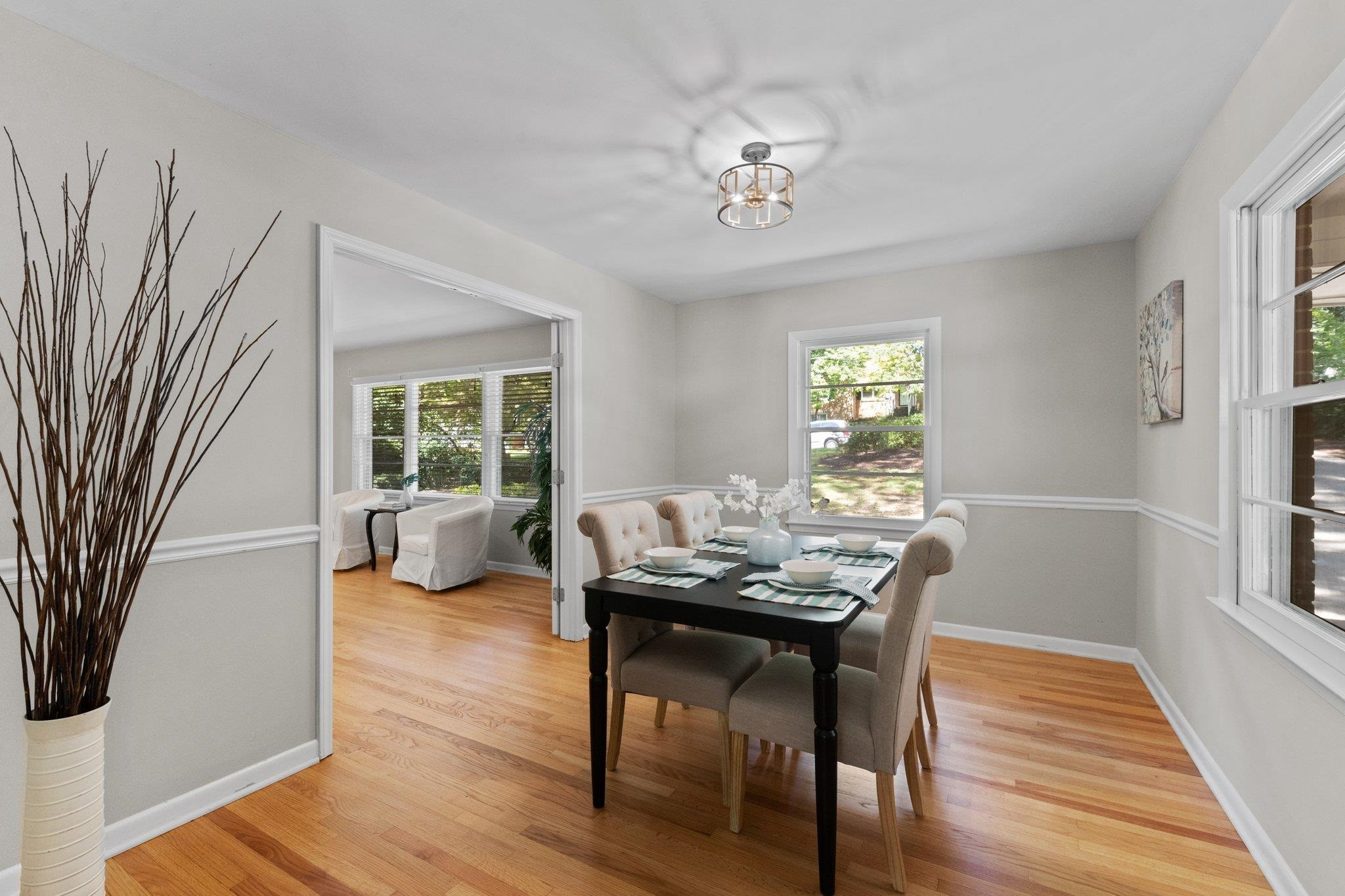 3605 Octavia Street Raleigh, NC 27606 - Photo 4 of 50 a dining room with furniture a chandelier and wooden floor