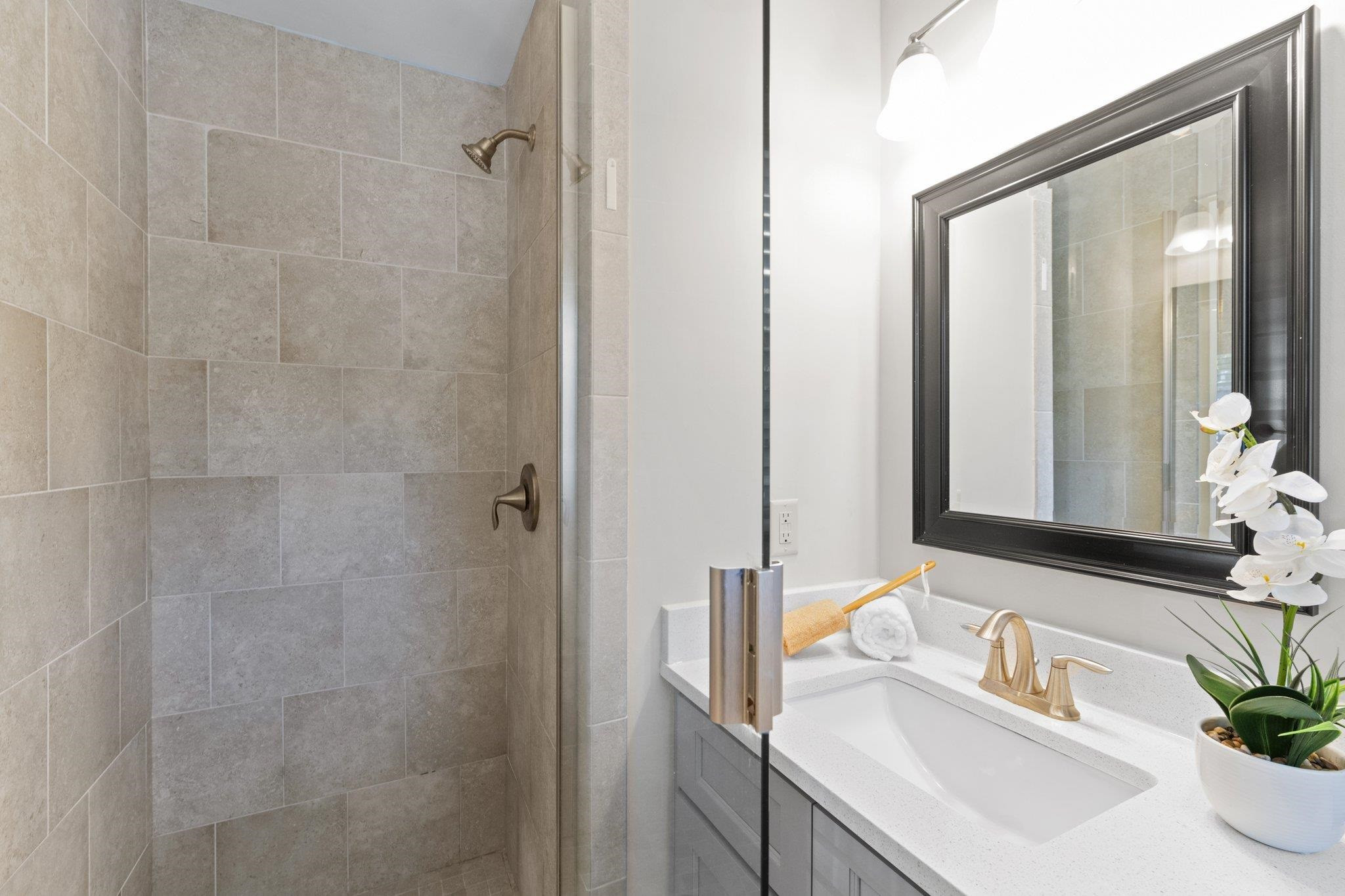 3605 Octavia Street Raleigh, NC 27606 - Photo 44 of 50 a bathroom with a sink and a mirror