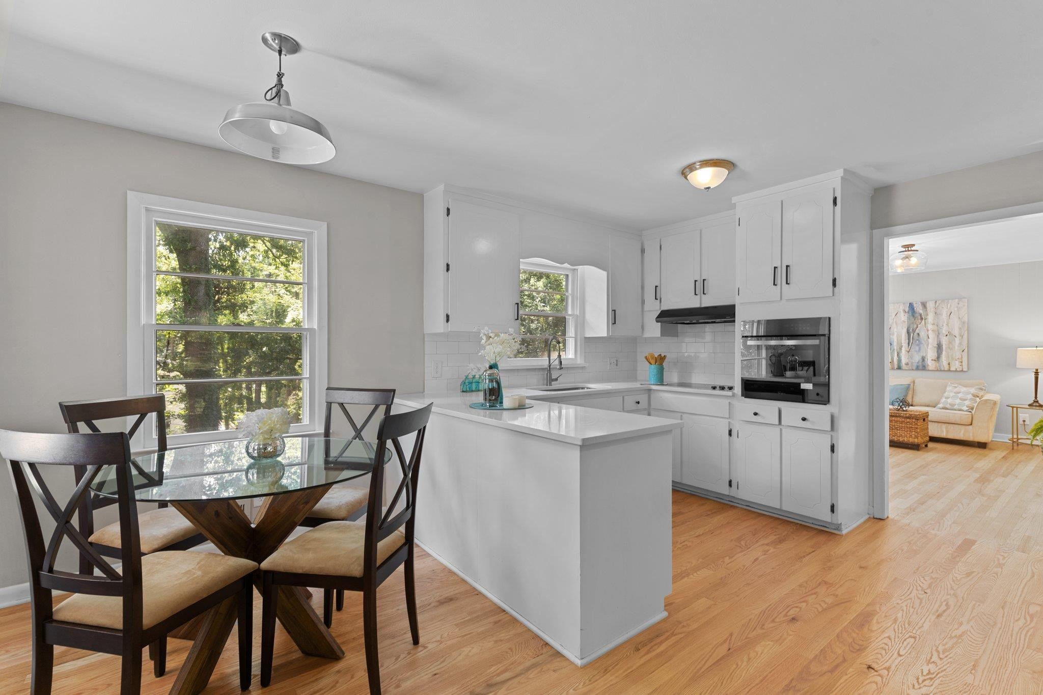 3605 Octavia Street Raleigh, NC 27606 - Photo 6 of 50 a kitchen with a dining table chairs and refrigerator