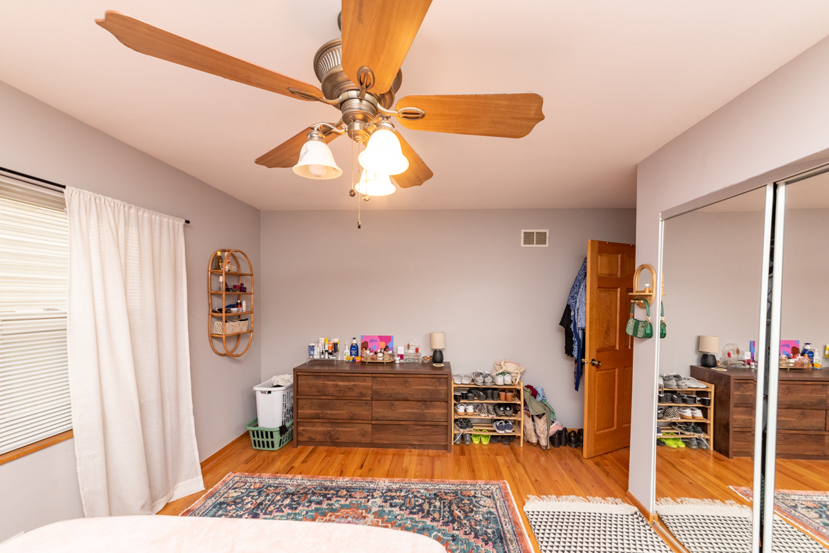 2932 North Ridgeway Avenue, Unit 1 Chicago, IL 60618 - Photo 11 of 25 a bedroom with a bed and a chandelier