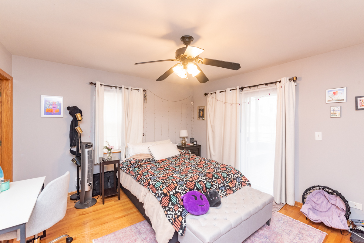 2932 North Ridgeway Avenue, Unit 1 Chicago, IL 60618 - Photo 14 of 25 a bedroom with a bed and a chandelier