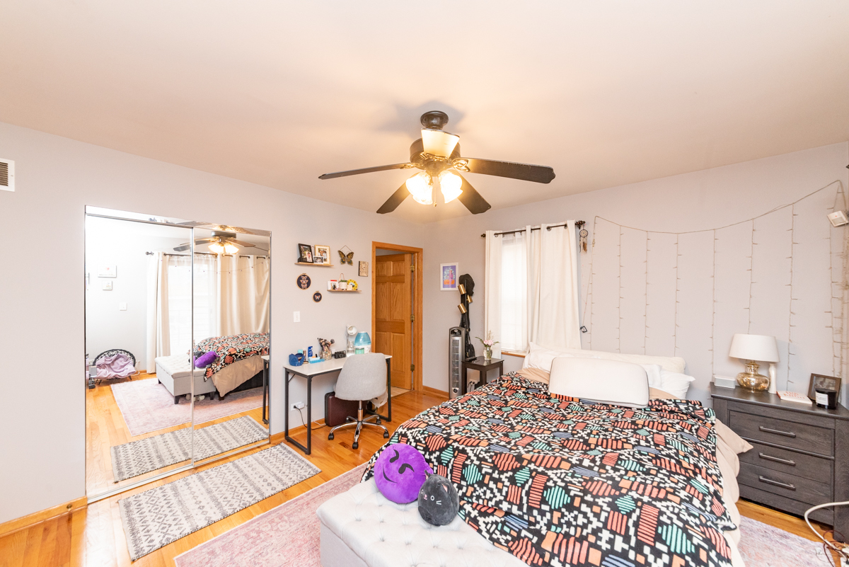 2932 North Ridgeway Avenue, Unit 1 Chicago, IL 60618 - Photo 15 of 25 a bedroom with furniture and a chandelier