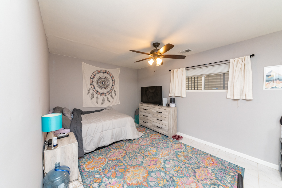 2932 North Ridgeway Avenue, Unit 1 Chicago, IL 60618 - Photo 17 of 25 a bedroom with a bed and a chandelier