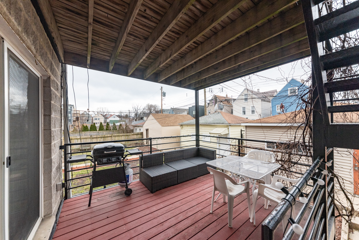 2932 North Ridgeway Avenue, Unit 1 Chicago, IL 60618 - Photo 22 of 25 a roof deck with table and chairs
