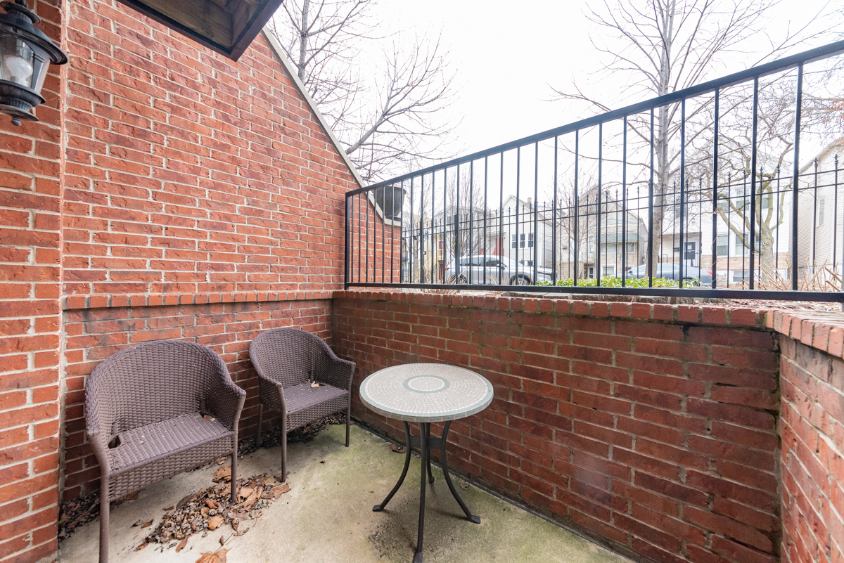 2932 North Ridgeway Avenue, Unit 1 Chicago, IL 60618 - Photo 24 of 25 a brick building with a sink and a chair