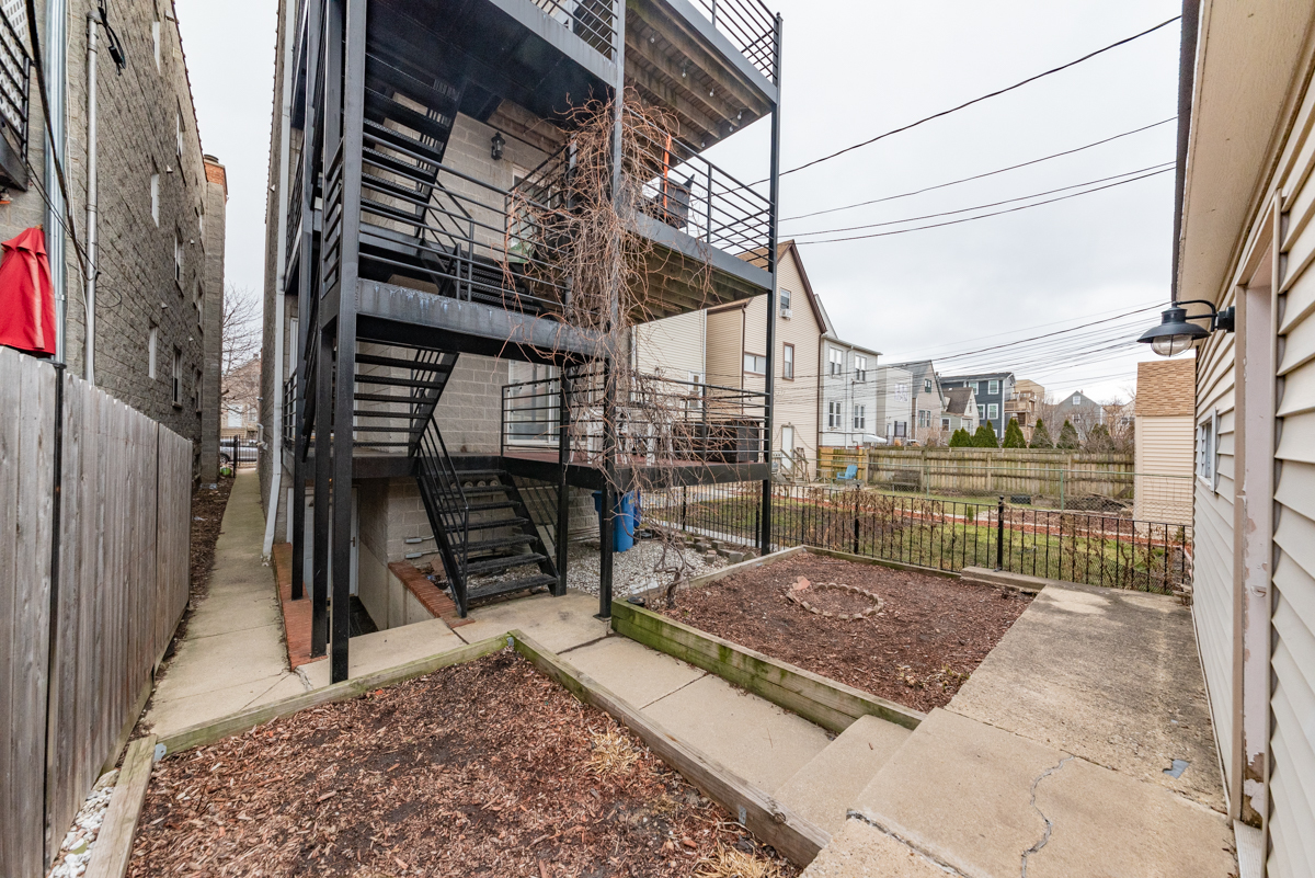 2932 North Ridgeway Avenue, Unit 1 Chicago, IL 60618 - Photo 25 of 25 a view of a backyard with a bench