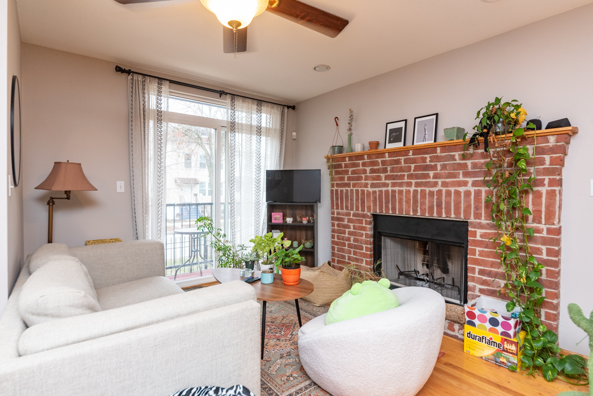 2932 North Ridgeway Avenue, Unit 1 Chicago, IL 60618 - Photo 6 of 25 a living room with furniture fireplace and a large window
