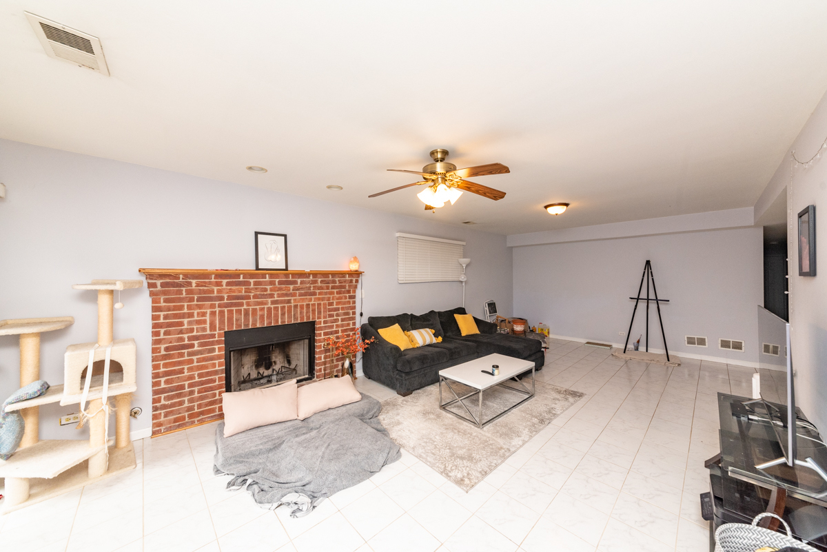 2932 North Ridgeway Avenue, Unit 1 Chicago, IL 60618 - Photo 7 of 25 a living room with furniture and a fireplace