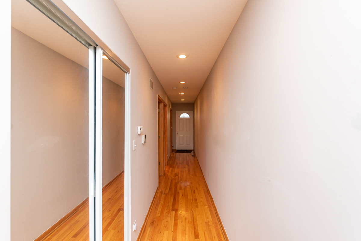 2932 North Ridgeway Avenue, Unit 1 Chicago, IL 60618 - Photo 9 of 25 a view of a hallway with wooden floor