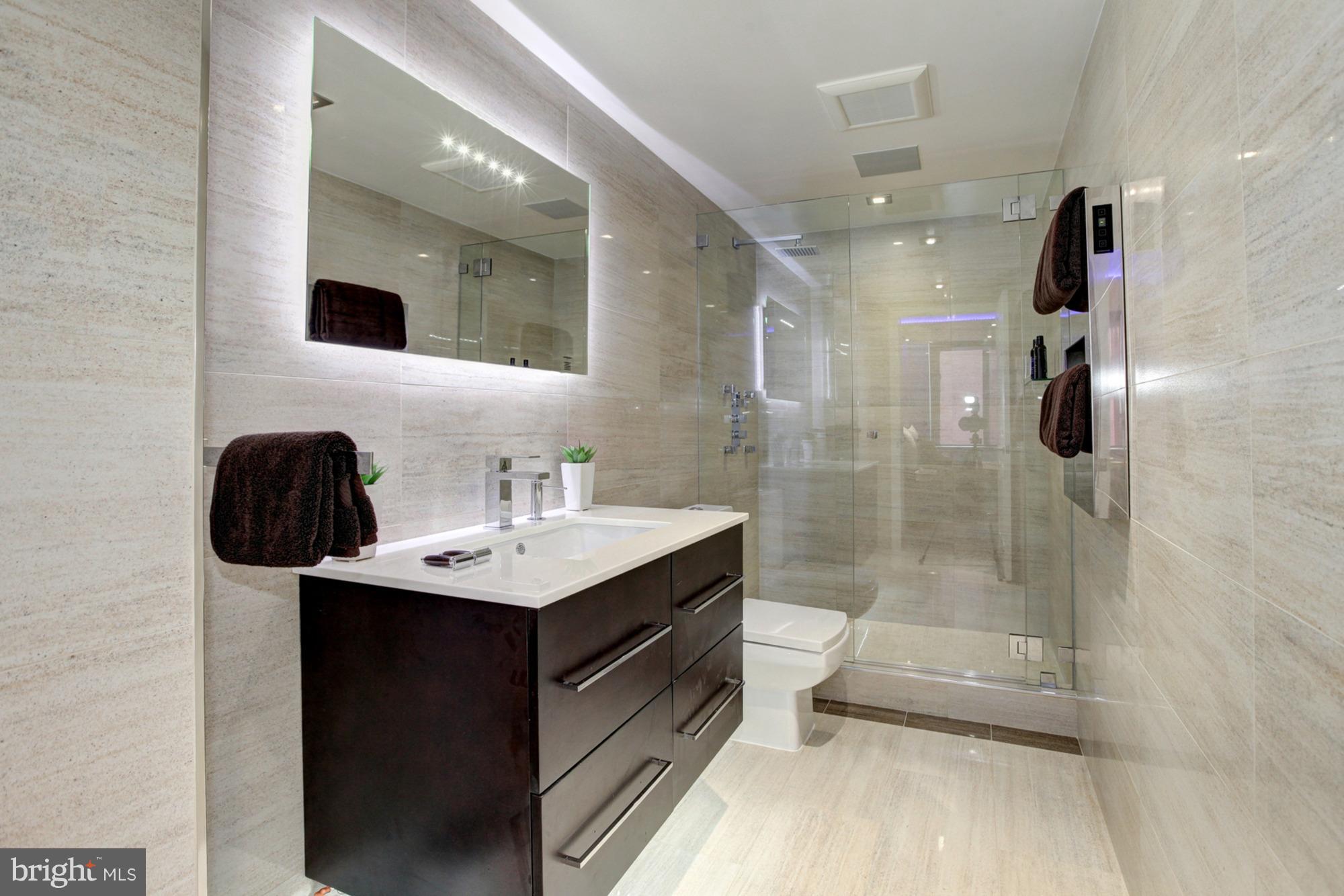 11710 Old Georgetown Road, Unit 208 North Bethesda, MD 20852 - Photo 12 of 28 a bathroom with a sink a toilet and shower