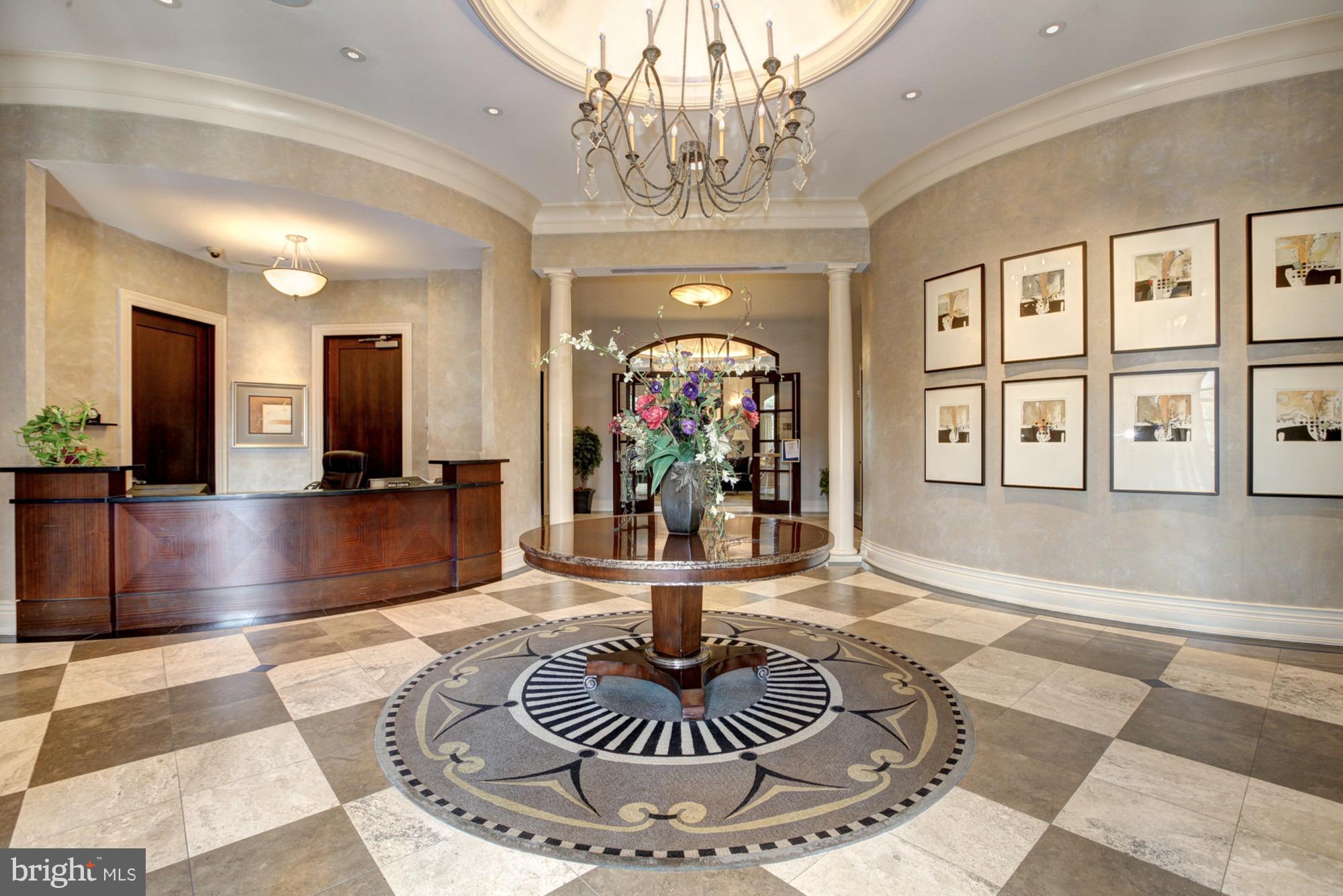 11710 Old Georgetown Road, Unit 208 North Bethesda, MD 20852 - Photo 20 of 28 a living room with furniture and a chandelier