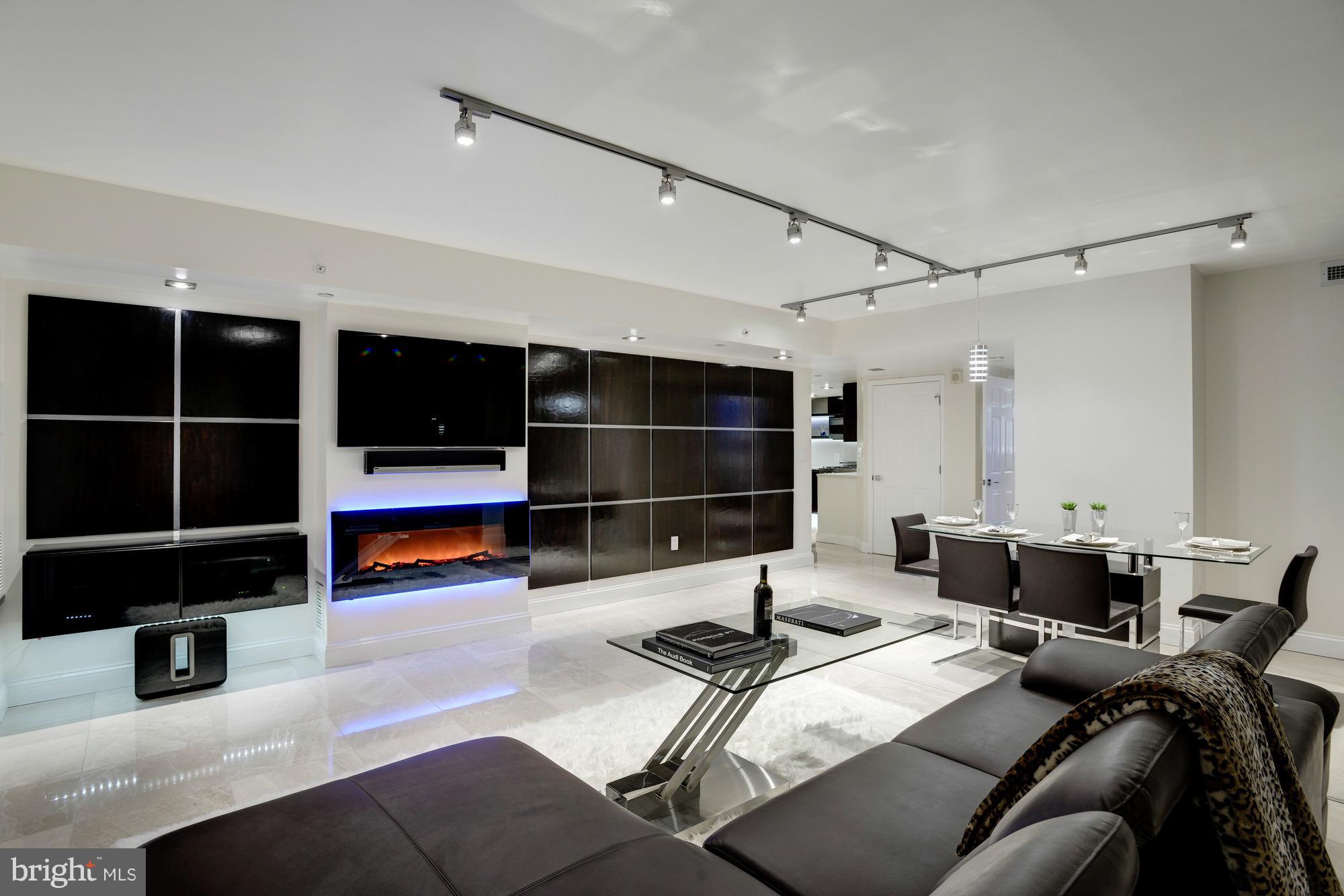 11710 Old Georgetown Road, Unit 208 North Bethesda, MD 20852 - Photo 4 of 28 a living room with furniture and a flat screen tv
