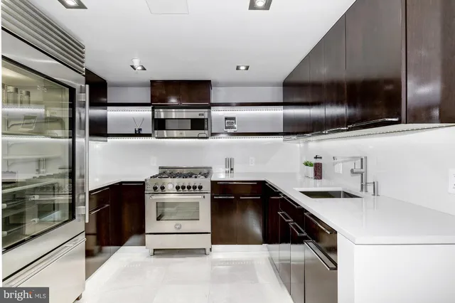 a kitchen with stainless steel appliances granite countertop a sink and a stove