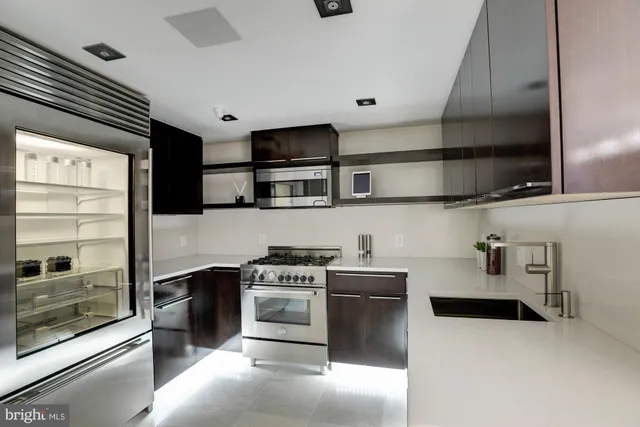 a kitchen with stainless steel appliances a stove a sink and a microwave