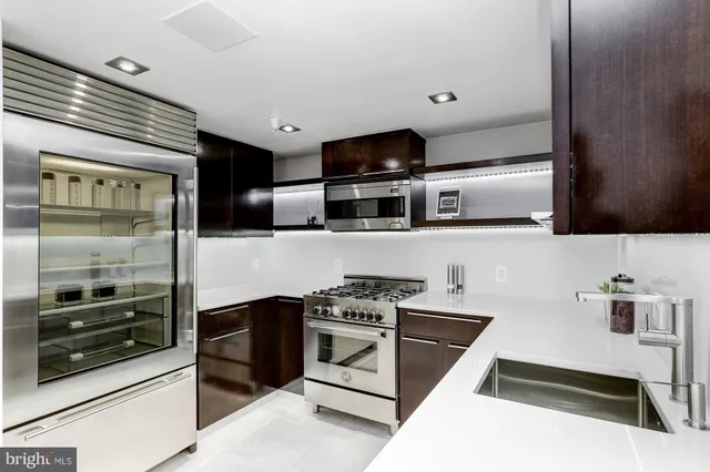 a kitchen with stainless steel appliances a stove a microwave and a refrigerator