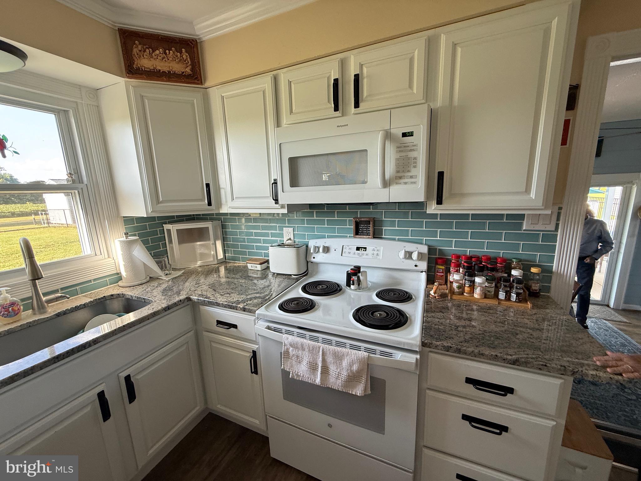 39030 Chaptico Road Mechanicsville, MD 20659 - Photo 16 of 23 a kitchen with stainless steel appliances granite countertop a sink and cabinets
