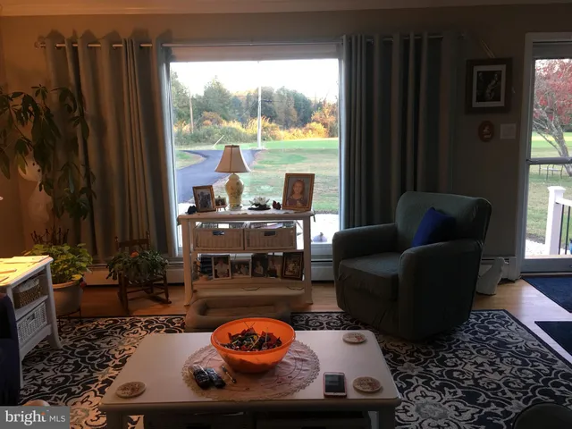 a living room with furniture and a floor to ceiling window