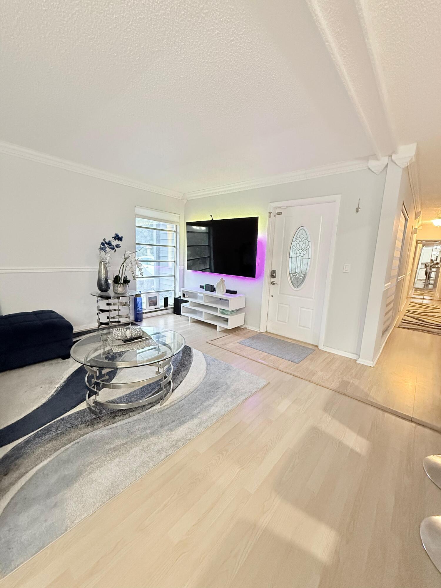 7024 Northwest 63rd Street Tamarac, FL 33321 - Photo 12 of 50 a room with a bed and a flat screen tv