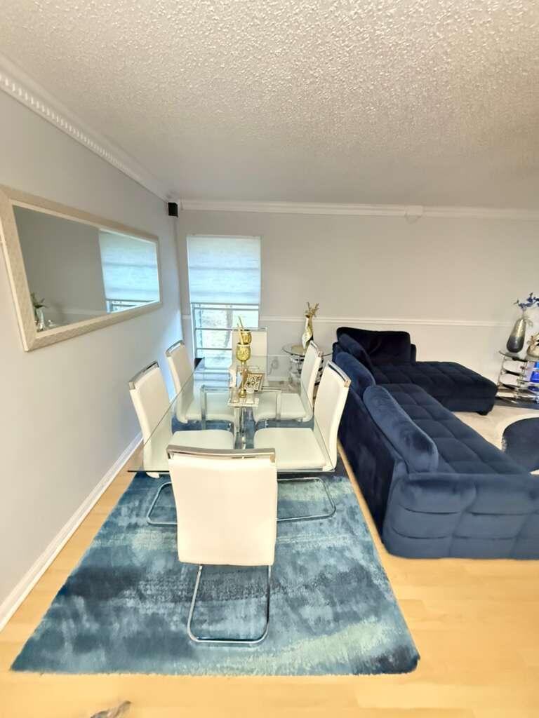 7024 Northwest 63rd Street Tamarac, FL 33321 - Photo 13 of 50 a living room with a couch and a rug