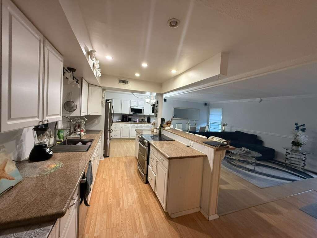 7024 Northwest 63rd Street Tamarac, FL 33321 - Photo 14 of 50 a kitchen with stainless steel appliances granite countertop a lot of counter space and cabinets