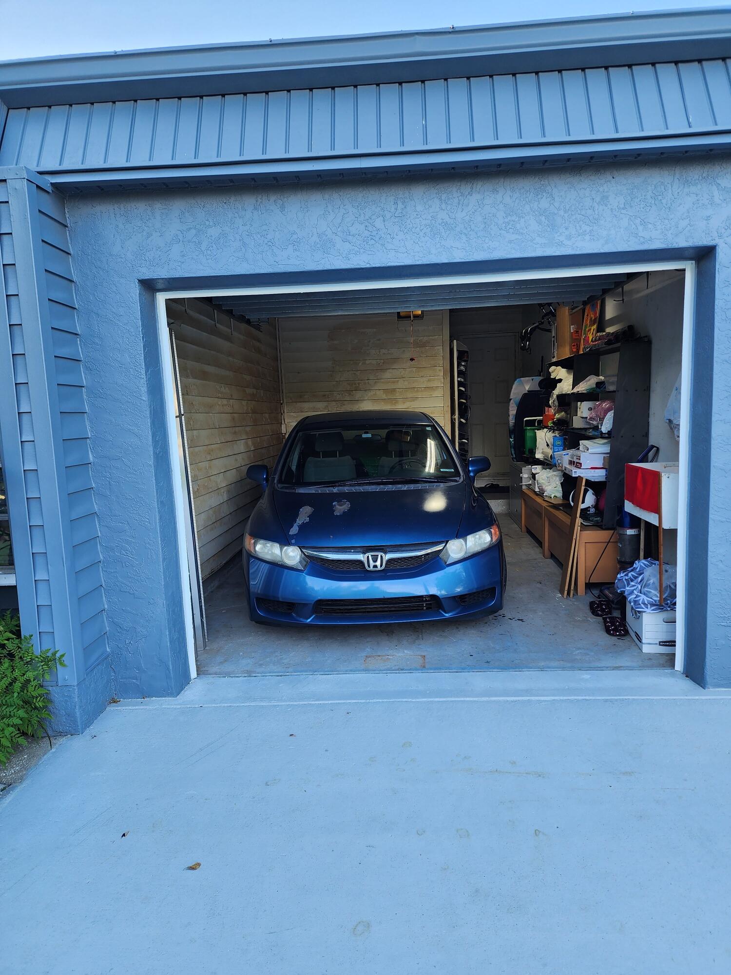 7024 Northwest 63rd Street Tamarac, FL 33321 - Photo 2 of 50 a car parked in garage