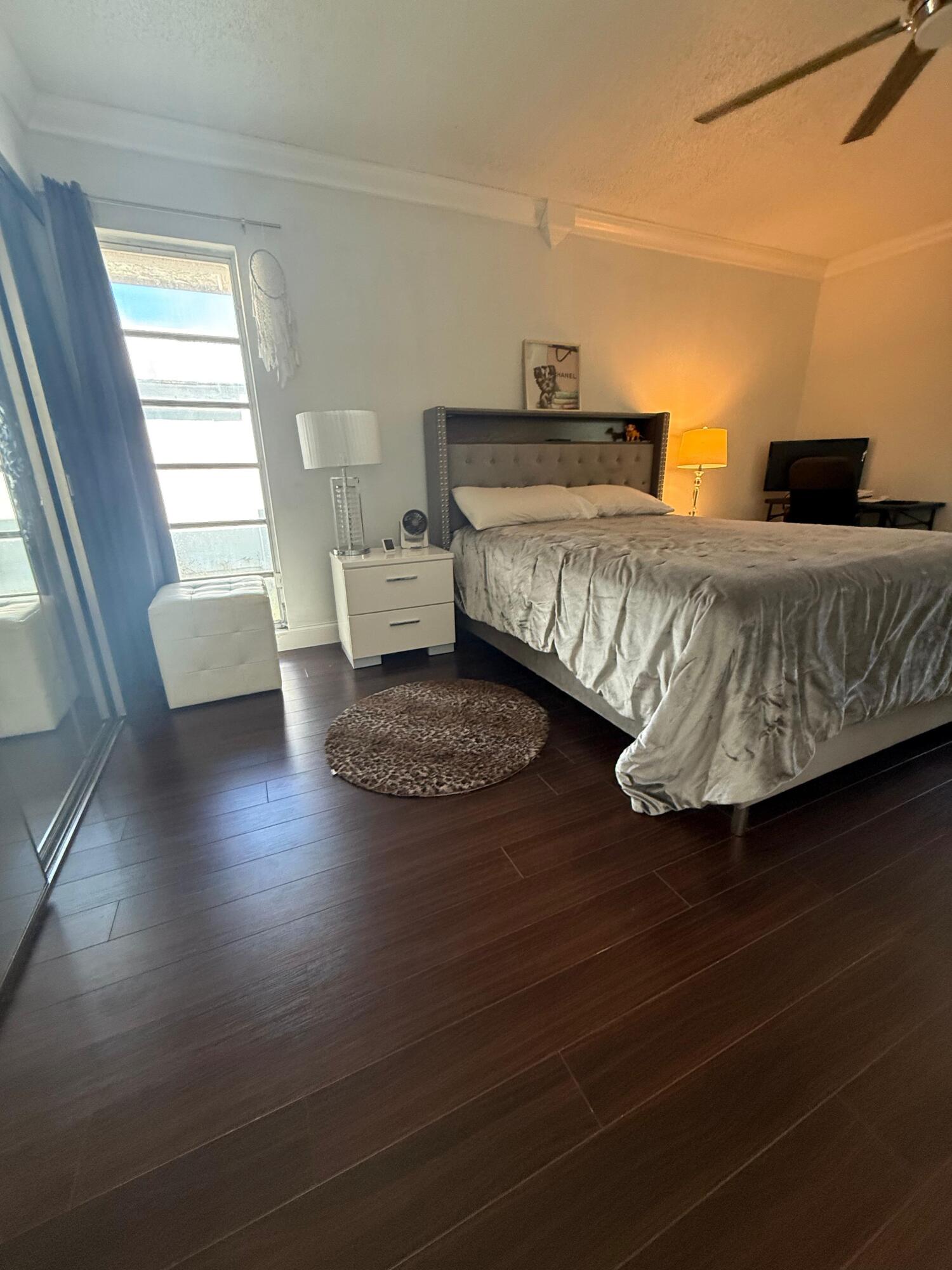 7024 Northwest 63rd Street Tamarac, FL 33321 - Photo 27 of 50 a bedroom with a bed and window