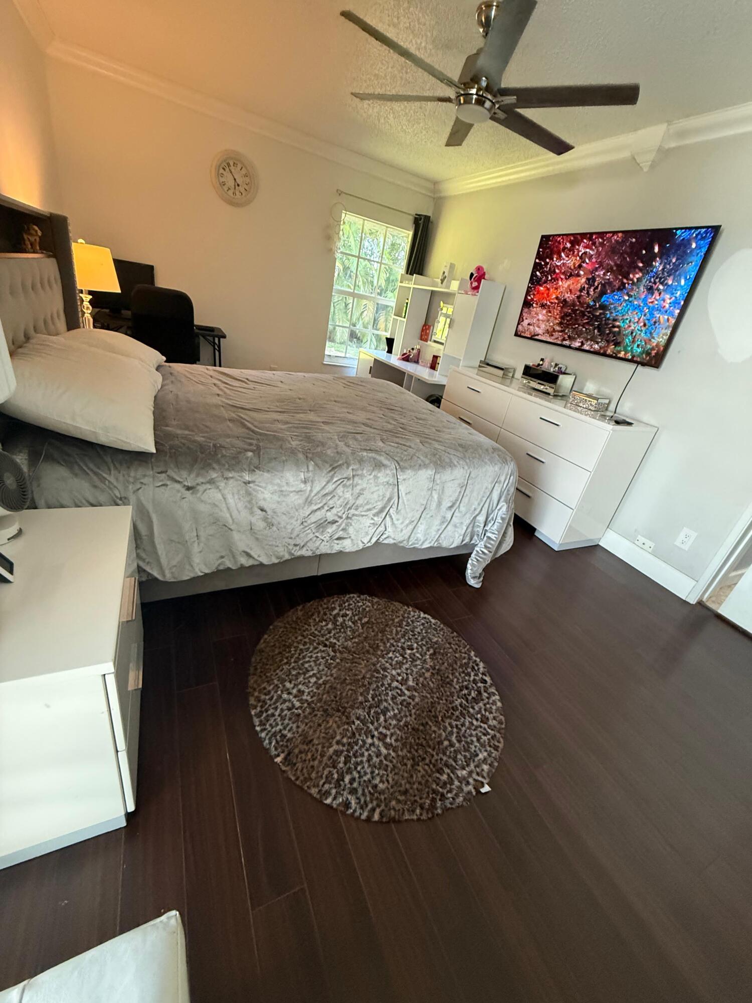 7024 Northwest 63rd Street Tamarac, FL 33321 - Photo 28 of 50 a living room with furniture and a flat screen tv