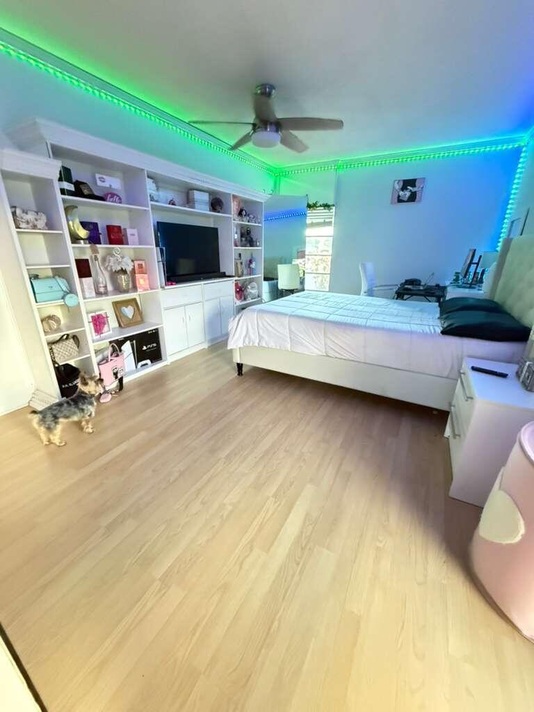 7024 Northwest 63rd Street Tamarac, FL 33321 - Photo 36 of 50 a living room with furniture and a flat screen tv