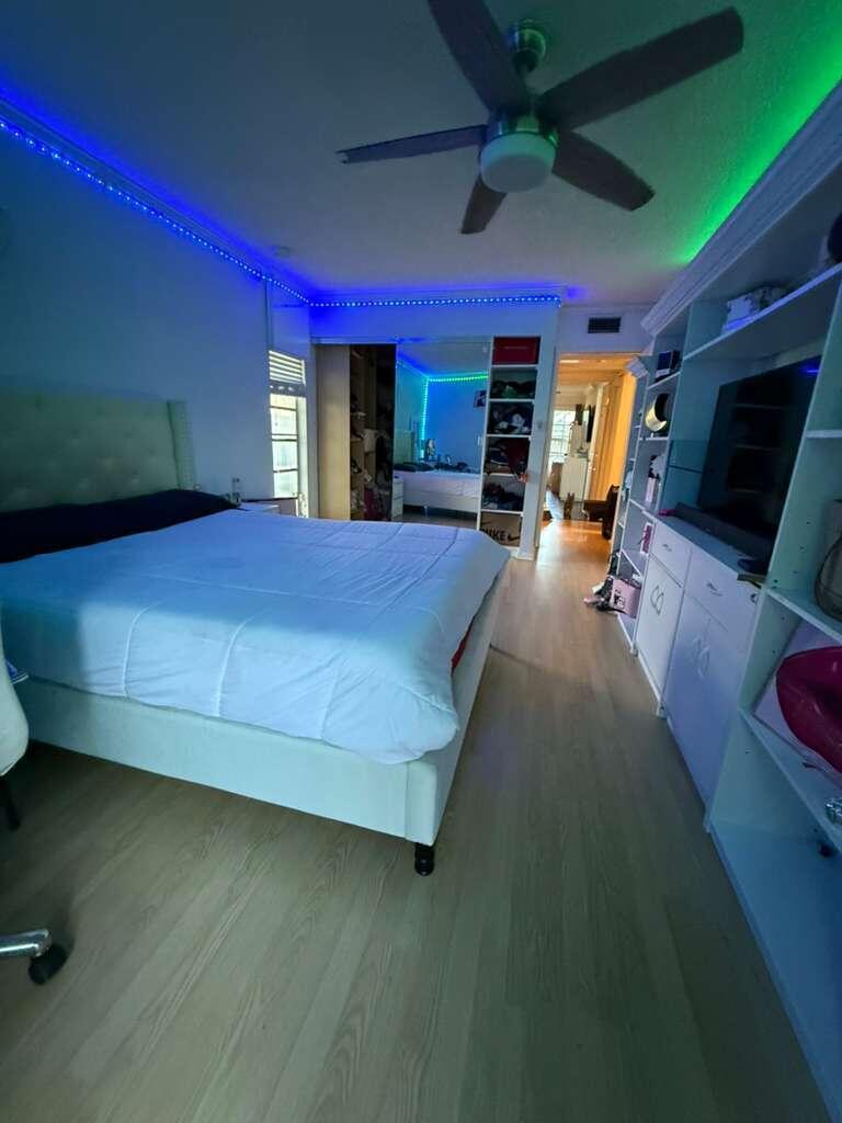 7024 Northwest 63rd Street Tamarac, FL 33321 - Photo 37 of 50 a bed sitting in a room next to a window