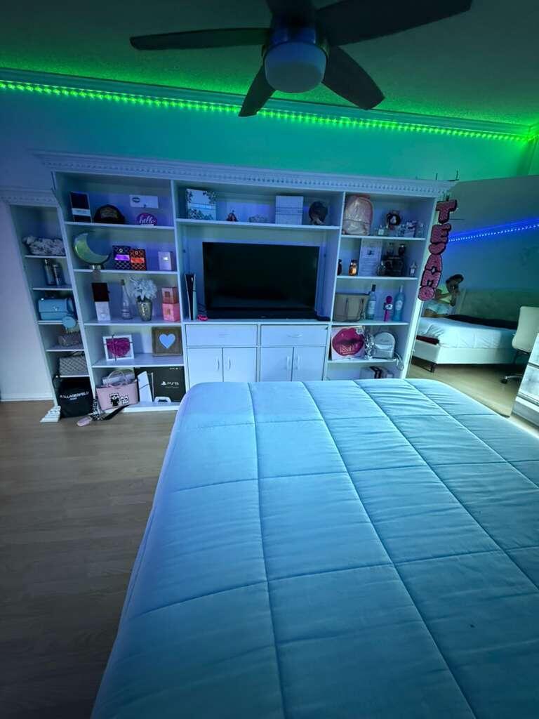 7024 Northwest 63rd Street Tamarac, FL 33321 - Photo 38 of 50 a living room with furniture and a flat screen tv