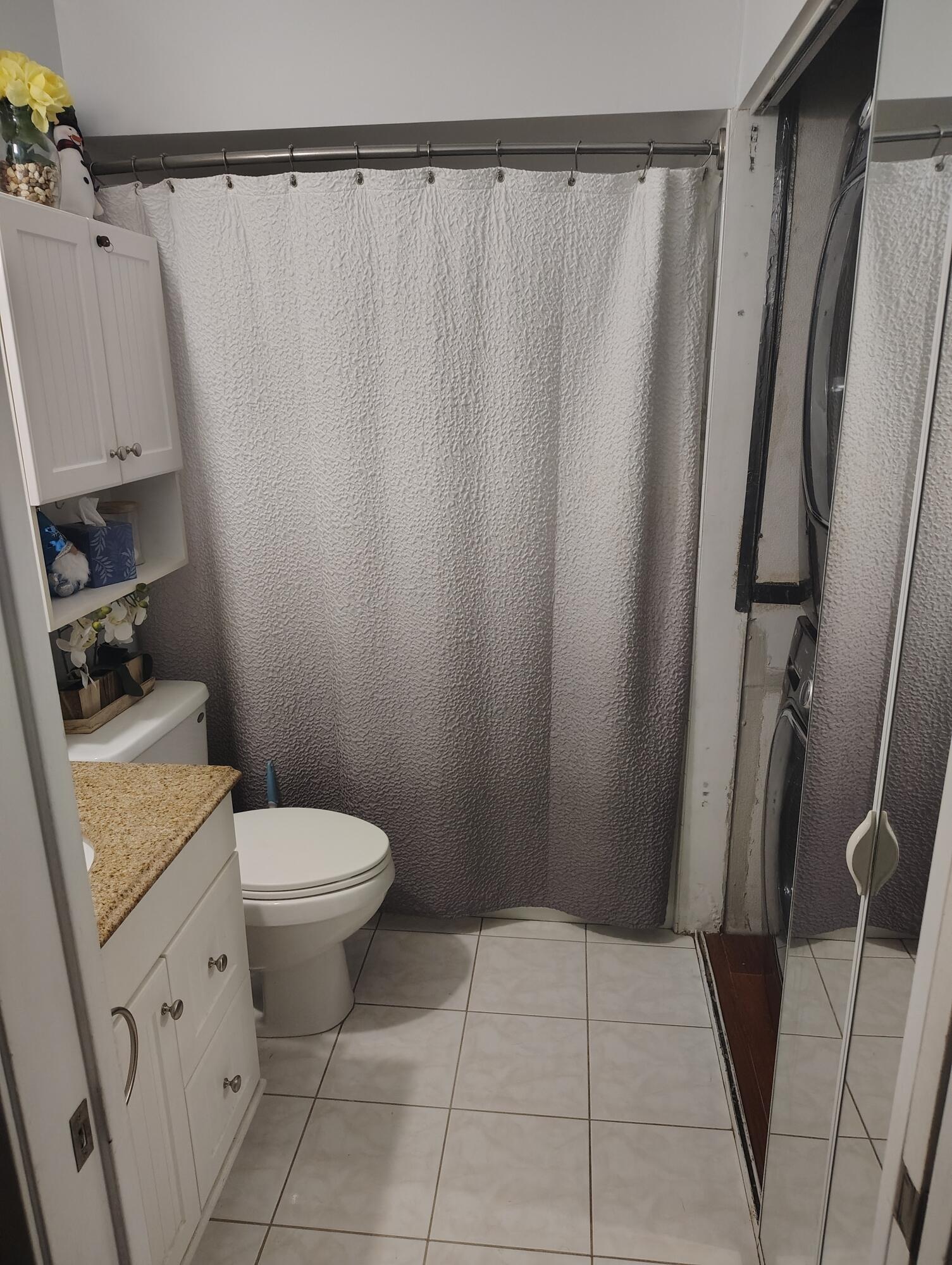 7024 Northwest 63rd Street Tamarac, FL 33321 - Photo 42 of 50 a bathroom with a sink a toilet a shower and a mirror