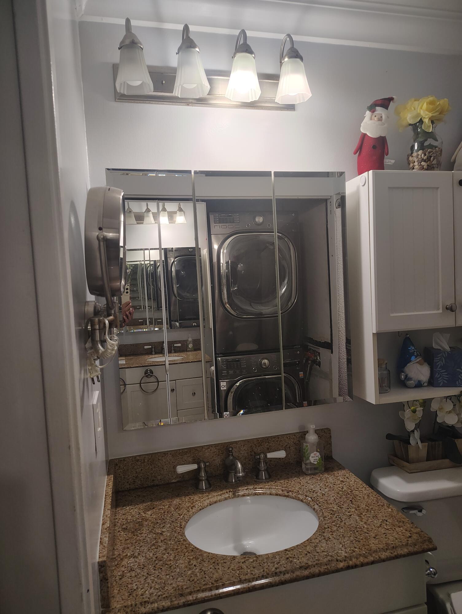 7024 Northwest 63rd Street Tamarac, FL 33321 - Photo 43 of 50 a bathroom with a granite countertop sink a mirror and shower