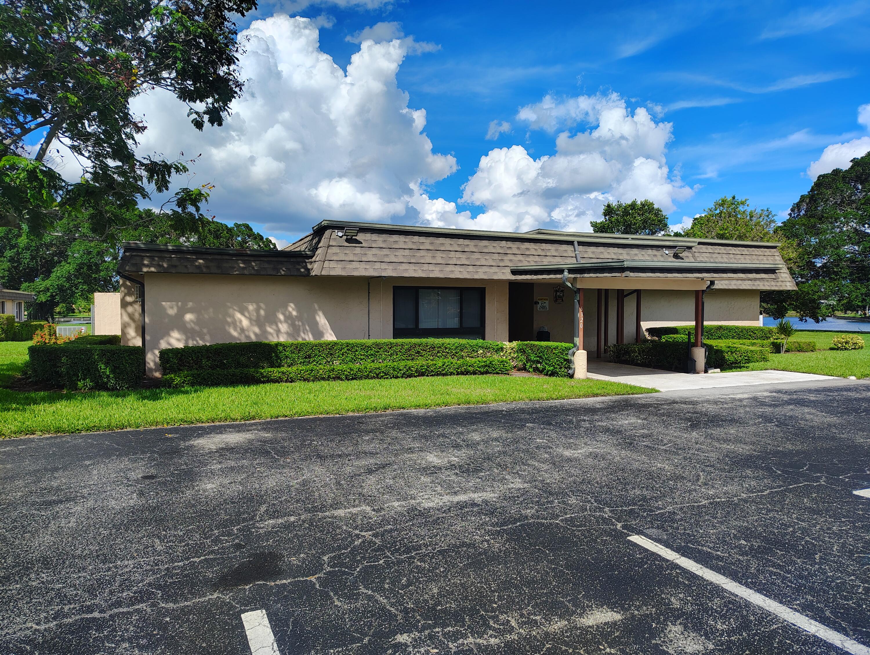 7024 Northwest 63rd Street Tamarac, FL 33321 - Photo 46 of 50 a view of a house with a yard and a large tree