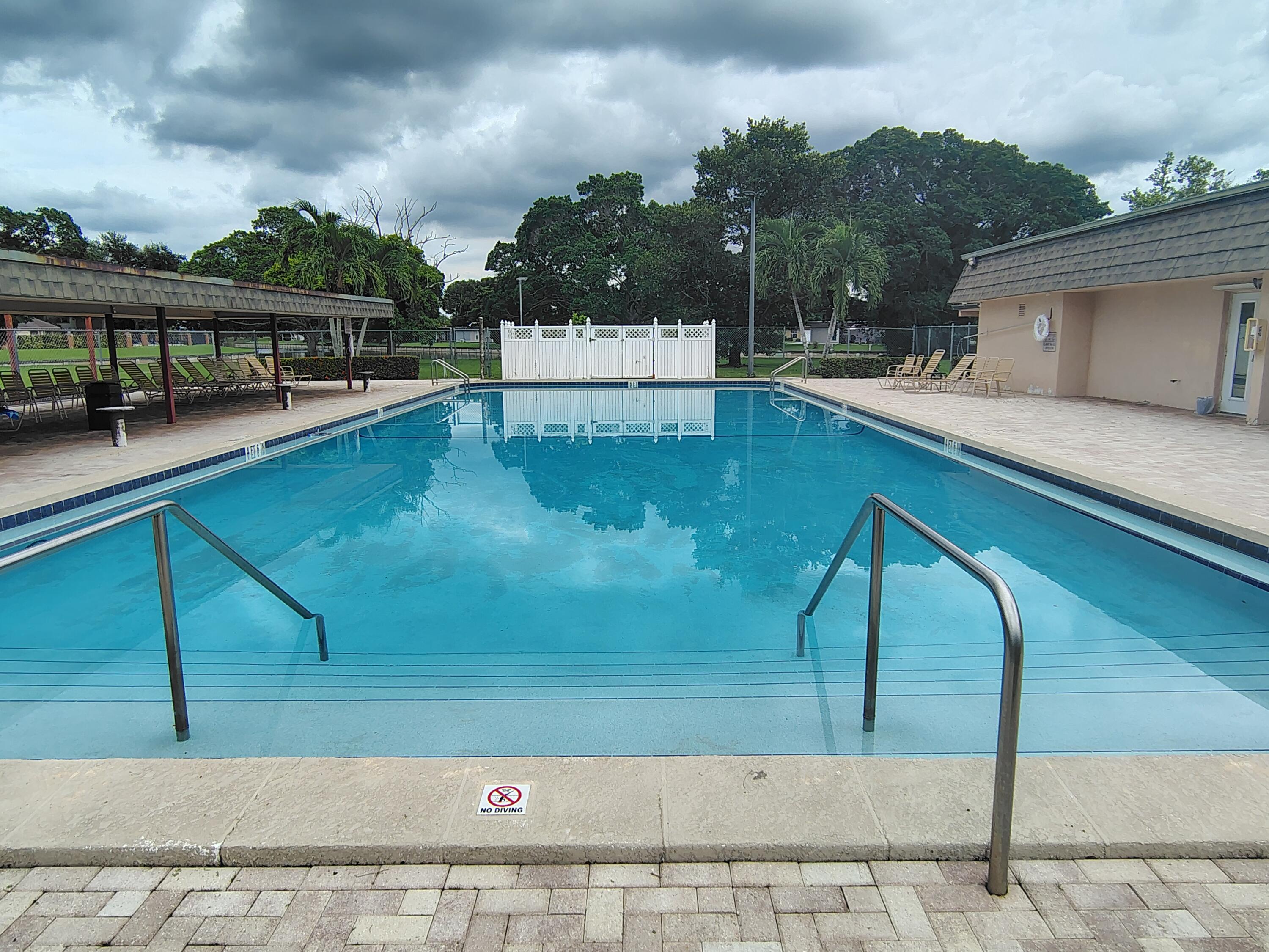 7024 Northwest 63rd Street Tamarac, FL 33321 - Photo 48 of 50 a view of a swimming pool with a patio