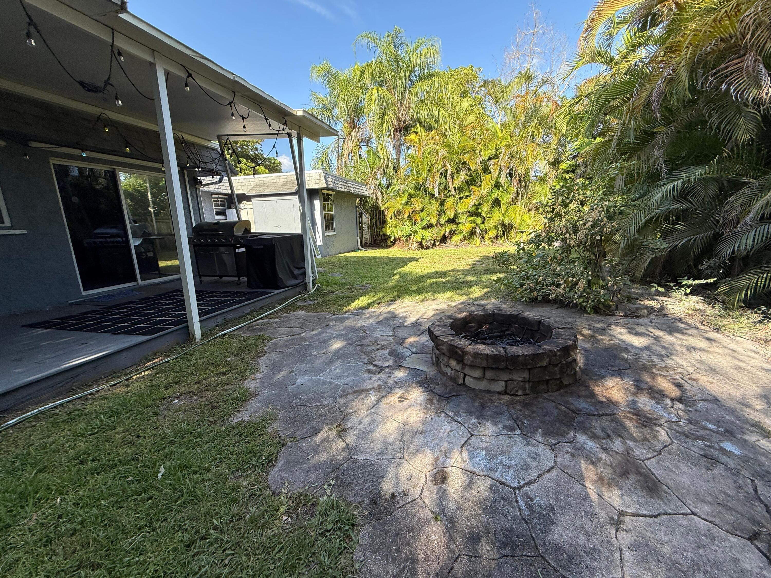 7024 Northwest 63rd Street Tamarac, FL 33321 - Photo 5 of 50 a view of a backyard
