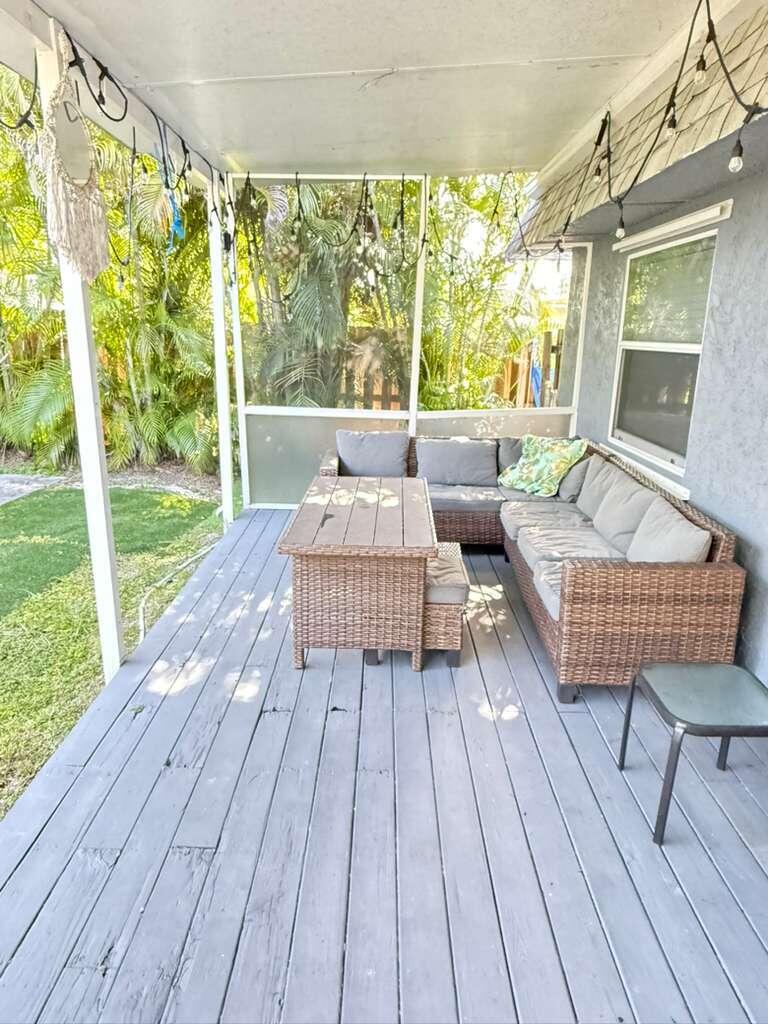 7024 Northwest 63rd Street Tamarac, FL 33321 - Photo 9 of 50 a balcony with wooden floor and outdoor seating