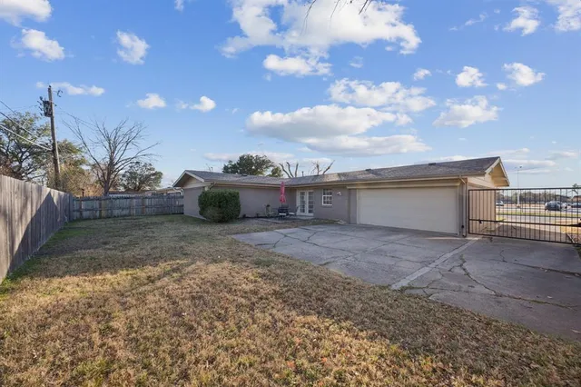 a view of a house with a backyard and a space