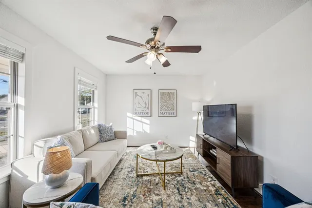 a living room with furniture a rug and a window