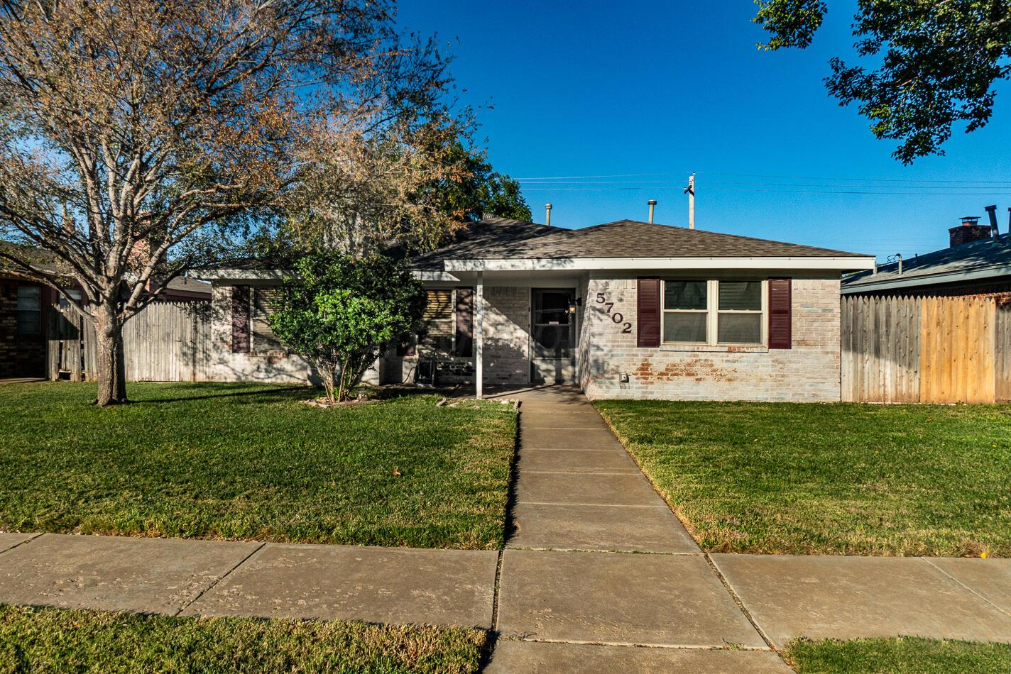 5702 South Milam Street Amarillo, TX 79110 - Photo 1 of 22 a front view of a house with a garden