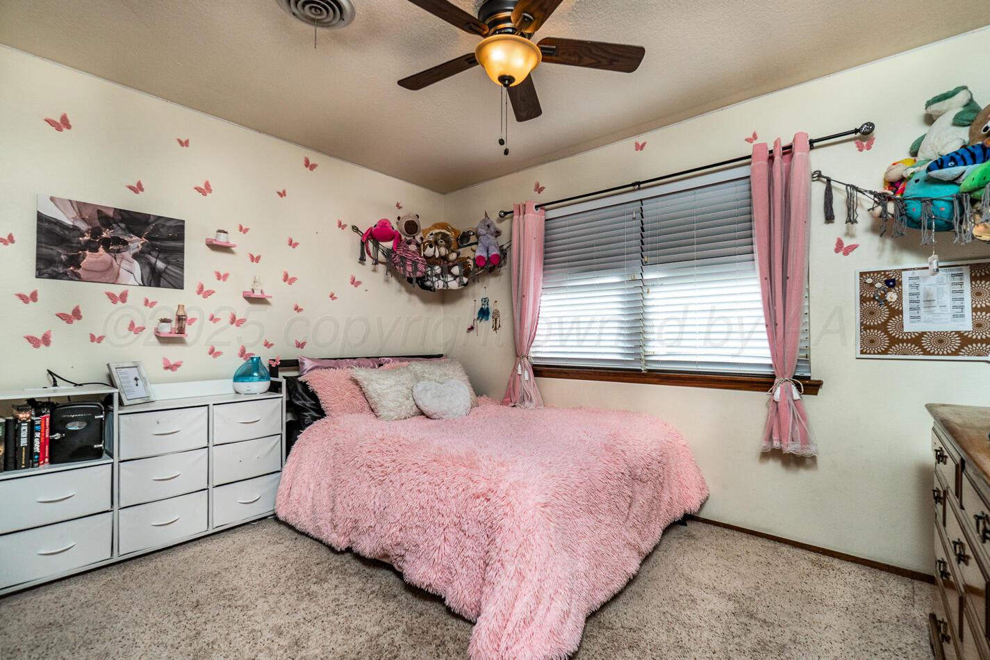 5702 South Milam Street Amarillo, TX 79110 - Photo 16 of 22 a bedroom with a bed and a window