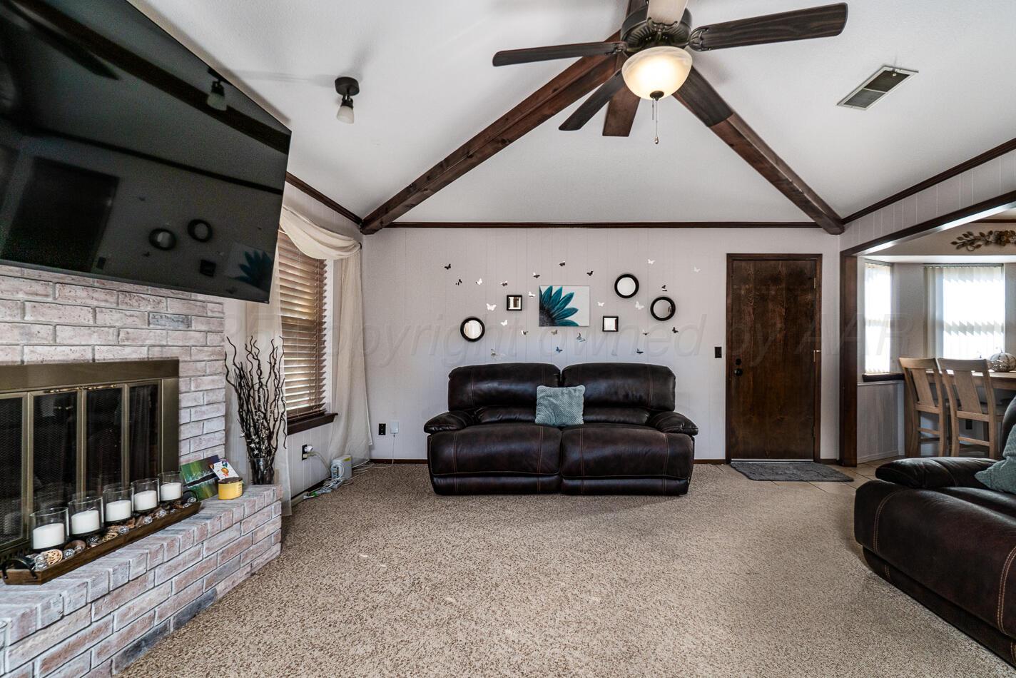 5702 South Milam Street Amarillo, TX 79110 - Photo 2 of 22 a bedroom with a bed and a couch