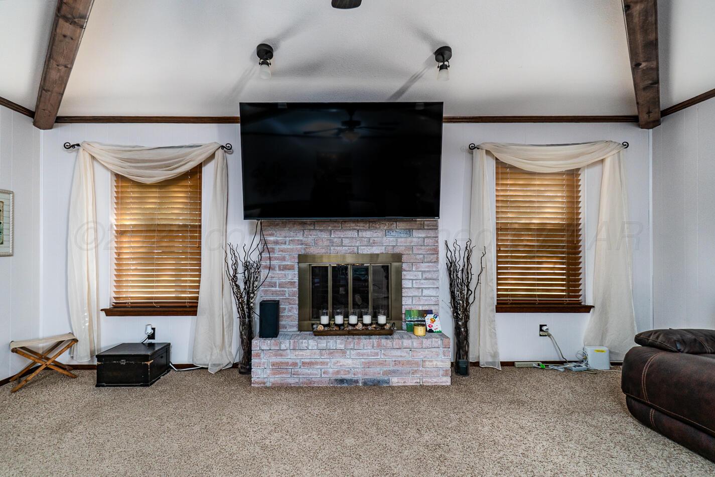5702 South Milam Street Amarillo, TX 79110 - Photo 8 of 22 a living room with furniture and a fireplace