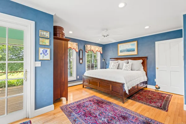 a bedroom with a bed and glass door