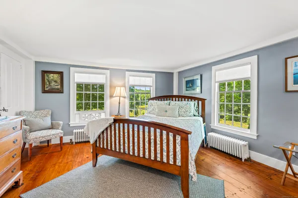 a bed sitting in a bedroom next to a window