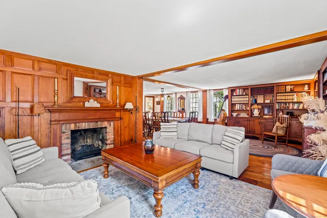 a living room with furniture a fireplace and city view