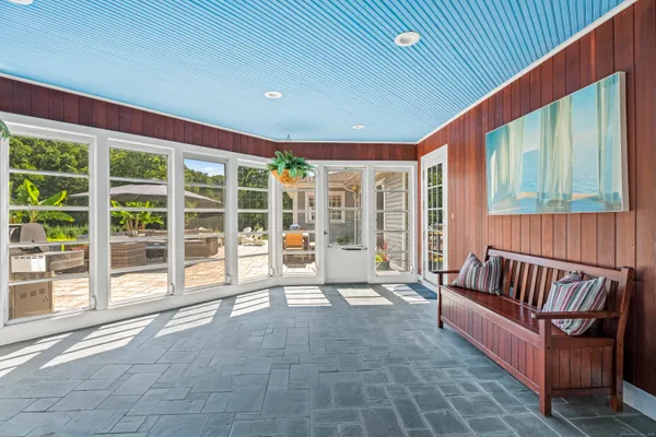 a spacious bedroom with a large window and a balcony