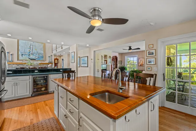 a kitchen with stainless steel appliances granite countertop a kitchen island a stove and a sink