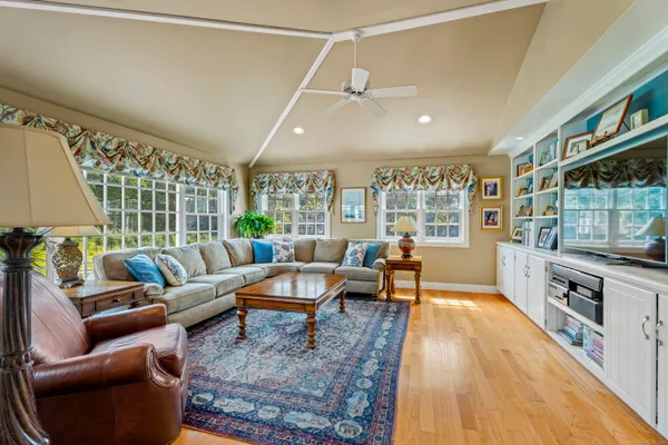 a living room with furniture and a wooden floor