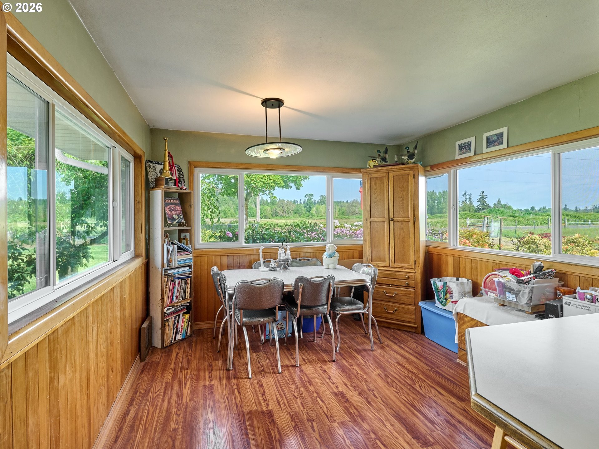 5724 South Anderson Road Aurora, OR 97002 - Photo 9 of 46 a view of a dining room with furniture window and wooden floor